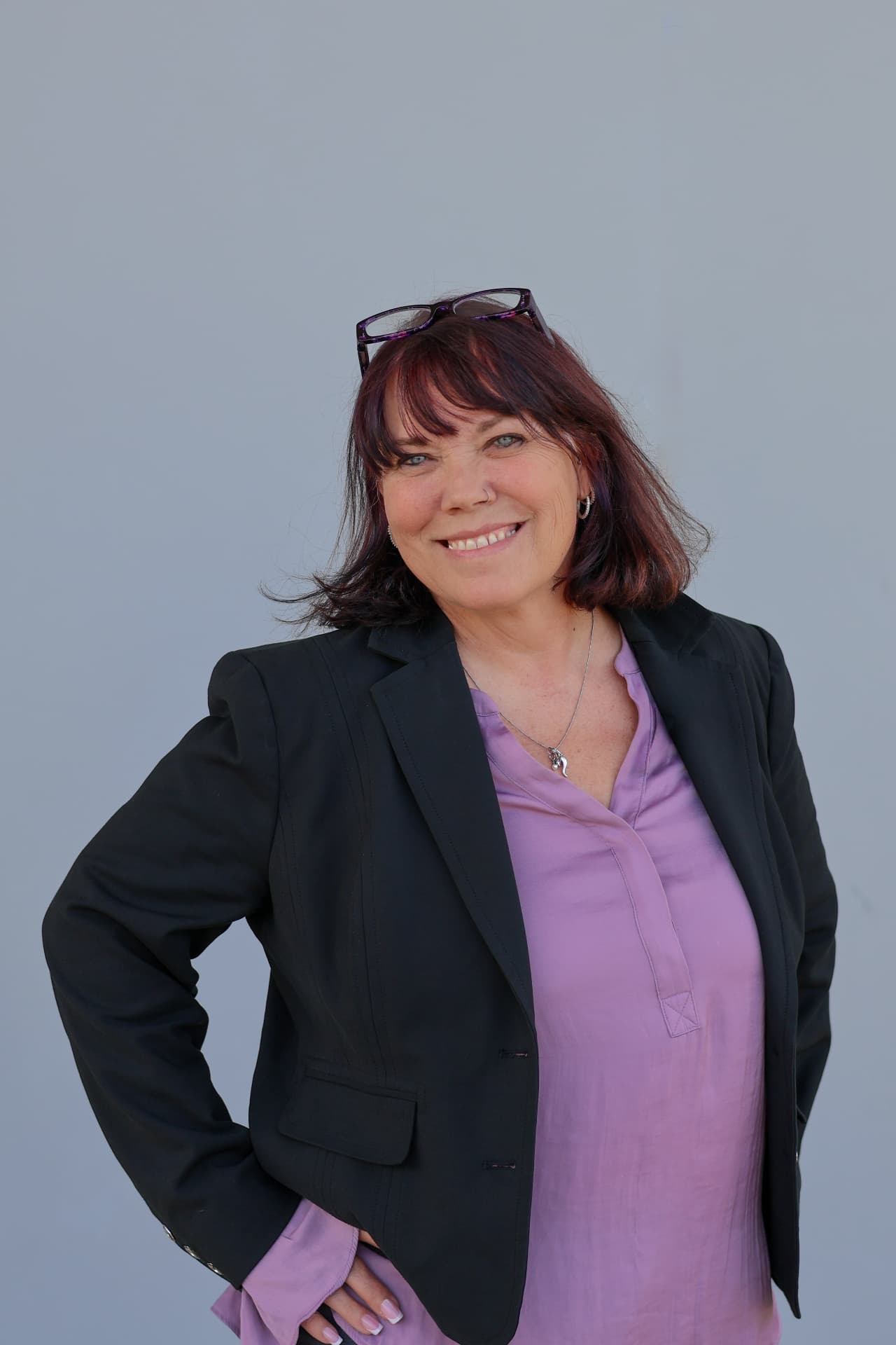 Portrait of Beth Ali smiling in a black blazer